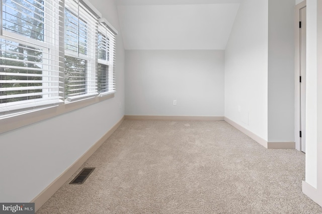 3708 Fairview Ave, Baltimore, MD 21216 - unfurnished room featuring light colored carpet and vaulted ceiling