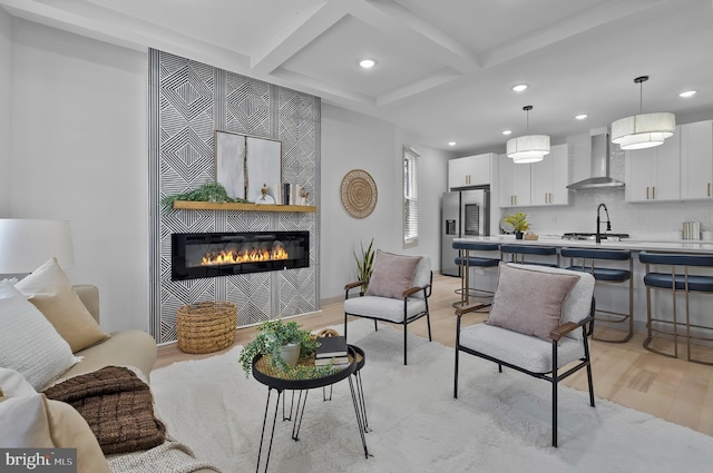 3708 Fairview Ave, Baltimore, MD 21216 - living area featuring coffered ceiling, recessed lighting, a tile fireplace, light wood-type flooring, and beamed ceiling