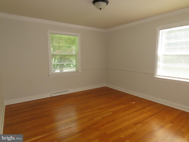 863 Yorklyn Rd, Hockessin, DE 19707 - empty room with plenty of natural light, light wood-style flooring, a baseboard radiator, and crown molding