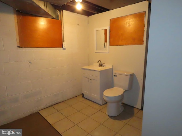 863 Yorklyn Rd, Hockessin, DE 19707 - half bath with vanity, concrete block wall, and tile patterned floors