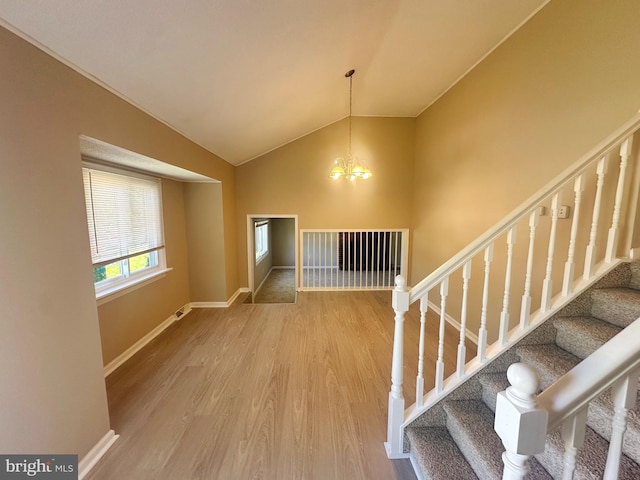 663 Topeka Ave, Mantua, NJ 08051 - stairway with a chandelier, wood finished floors, and vaulted ceiling