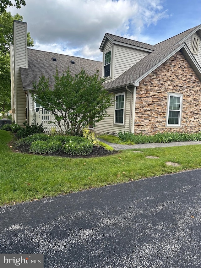 53 Apple Jack Ln, Littlestown, PA 17340 - view of property exterior with stone siding, a shingled roof, a chimney, and a yard