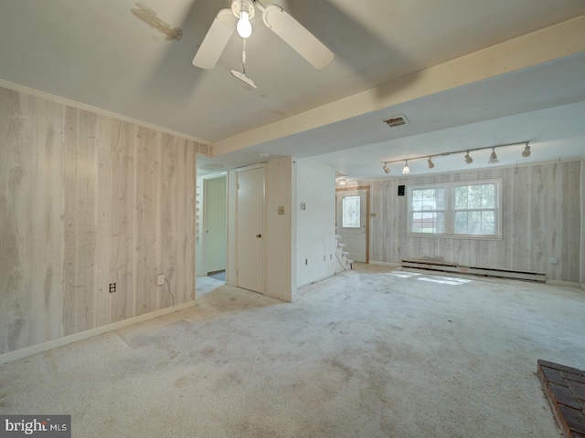 13217 Kephart Ln, Woodbridge, VA 22193 - spare room with a baseboard heating unit, wooden walls, ceiling fan, carpet floors, and track lighting