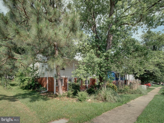 13217 Kephart Ln, Woodbridge, VA 22193 - view of property exterior featuring brick siding and a yard