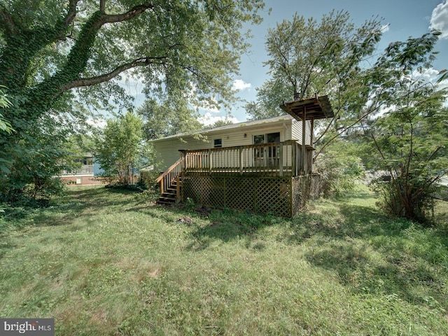 13217 Kephart Ln, Woodbridge, VA 22193 - back of house with a wooden deck and a lawn