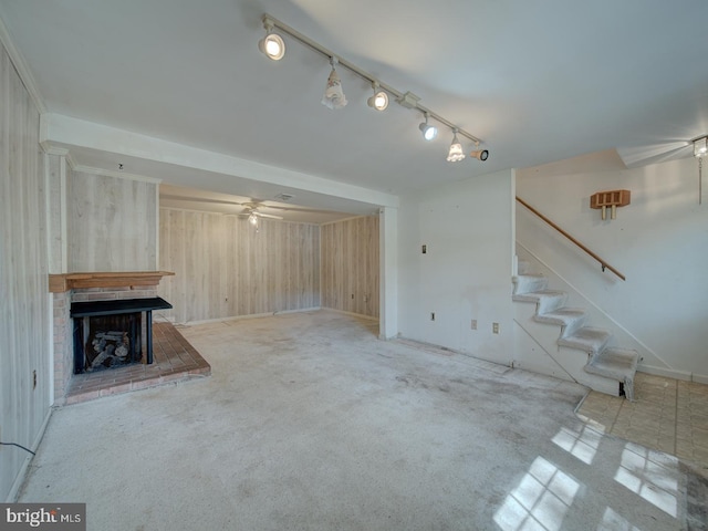13217 Kephart Ln, Woodbridge, VA 22193 - unfurnished living room with wooden walls, a brick fireplace, stairway, carpet, and a ceiling fan