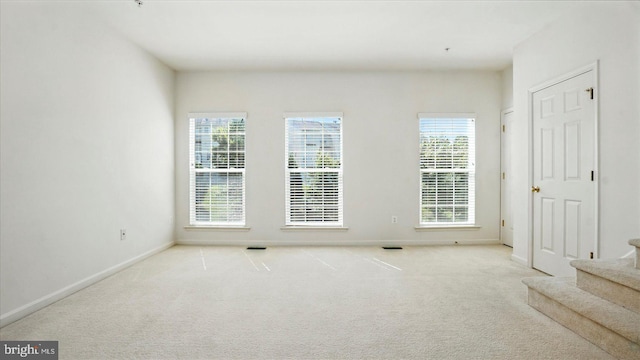 28 Buttonwood Ct, Baltimore, MD 21237 - carpeted empty room featuring stairs and plenty of natural light