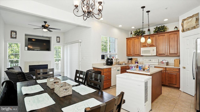 28 Buttonwood Ct, Baltimore, MD 21237 - kitchen featuring white appliances, light countertops, a kitchen island, brown cabinetry, and ceiling fan