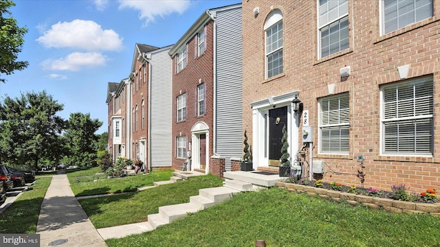 28 Buttonwood Ct, Baltimore, MD 21237 - view of front facade featuring a front yard and brick siding