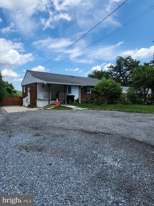 5503 Lanham Station Rd, Lanham, MD 20706 - single story home with a porch, brick siding, and gravel driveway