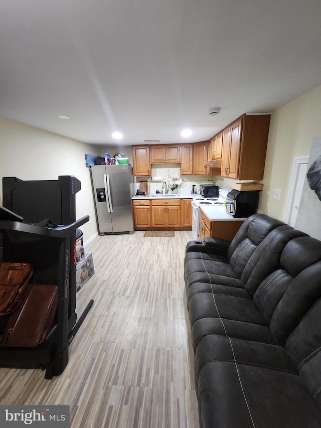 5503 Lanham Station Rd, Lanham, MD 20706 - kitchen featuring stainless steel refrigerator with ice dispenser, open floor plan, light countertops, electric stove, and light wood-type flooring