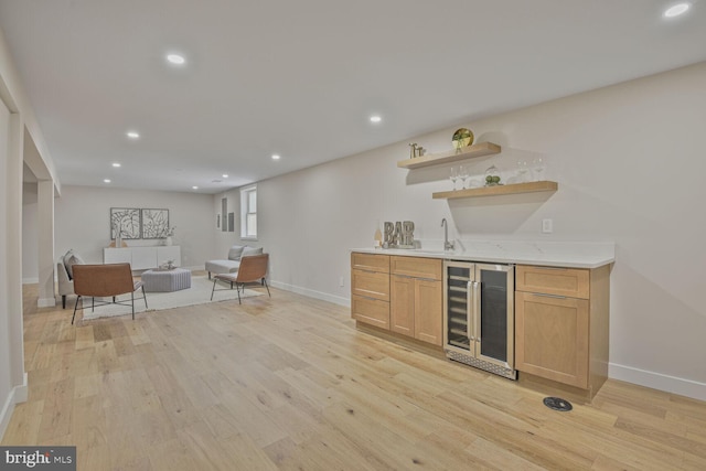 8328 Tuckerman Ln, Potomac, MD 20854 - indoor wet bar featuring beverage cooler, light wood finished floors, and recessed lighting