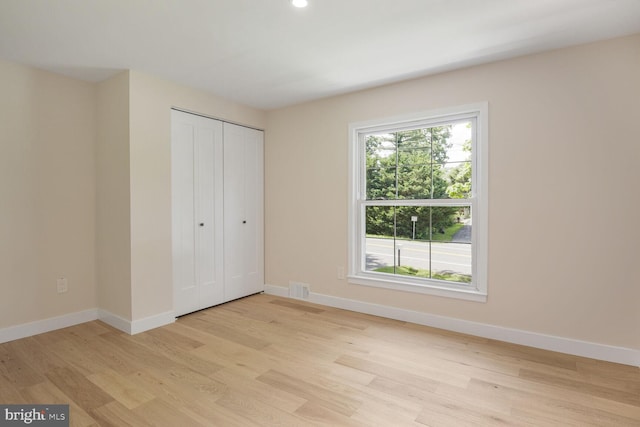 8328 Tuckerman Ln, Potomac, MD 20854 - unfurnished bedroom featuring light wood finished floors, a closet, and recessed lighting