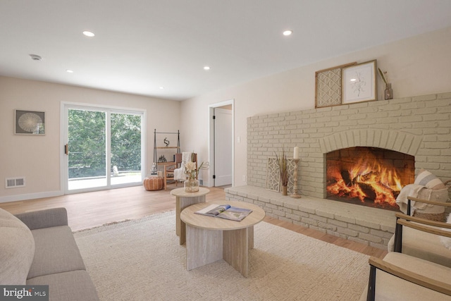 8328 Tuckerman Ln, Potomac, MD 20854 - living area with light wood-type flooring, a fireplace, and recessed lighting