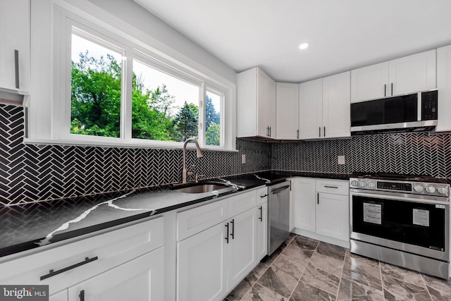 277 Ardmore Ave, Lansdowne, PA 19050 - kitchen with appliances with stainless steel finishes, dark countertops, white cabinets, and recessed lighting