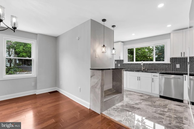 277 Ardmore Ave, Lansdowne, PA 19050 - kitchen with dishwasher, dark countertops, tasteful backsplash, white cabinets, and light wood-type flooring