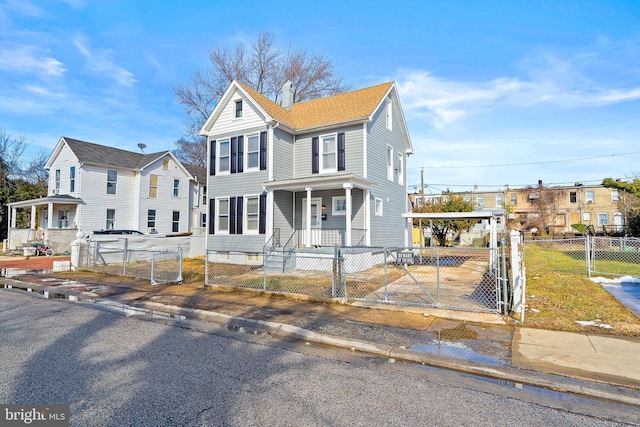5309 Ethelbert Ave, Baltimore, MD 21215 - view of front of house with a porch, a fenced front yard, a gate, and a detached carport