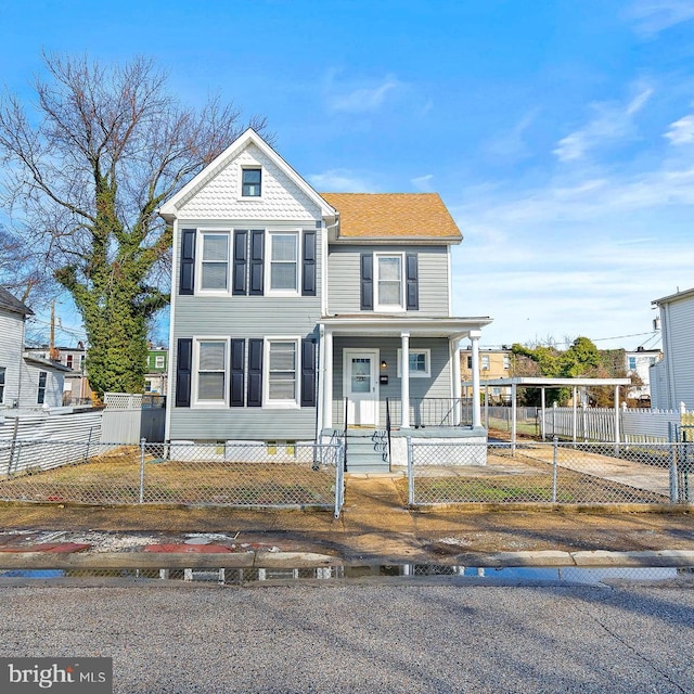 5309 Ethelbert Ave, Baltimore, MD 21215 - view of front of property with a porch, a fenced front yard, and a carport