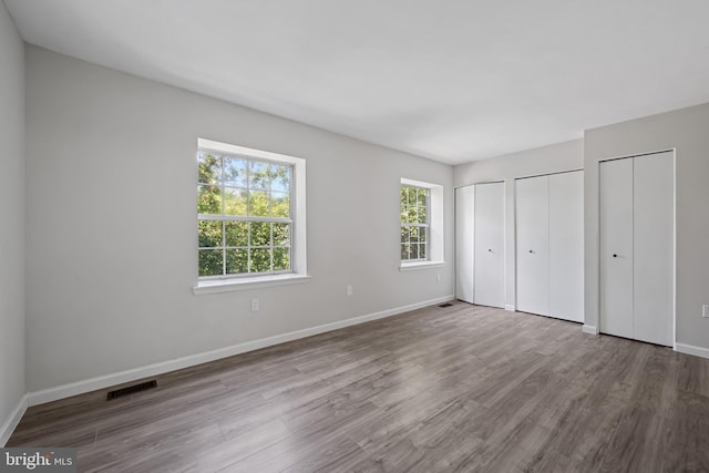 5783 Katsura Ct, Frederick, MD 21703 - unfurnished bedroom with two closets and wood finished floors