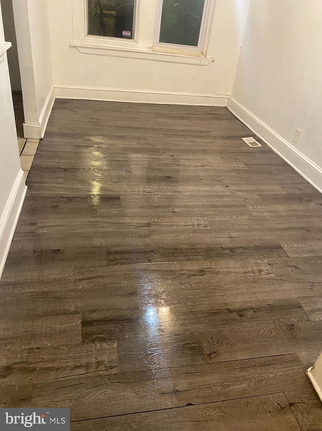 5219 Beaumont Ave, Philadelphia, PA 19143 - spare room with baseboards and dark wood-style flooring