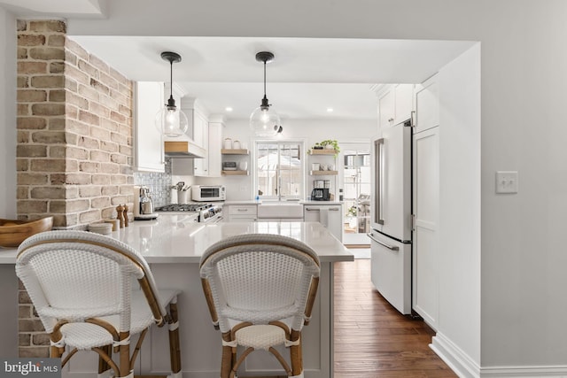 2140 Saint Albans St, Philadelphia, PA 19146 - kitchen featuring dishwasher, high end fridge, open shelves, a peninsula, and stove