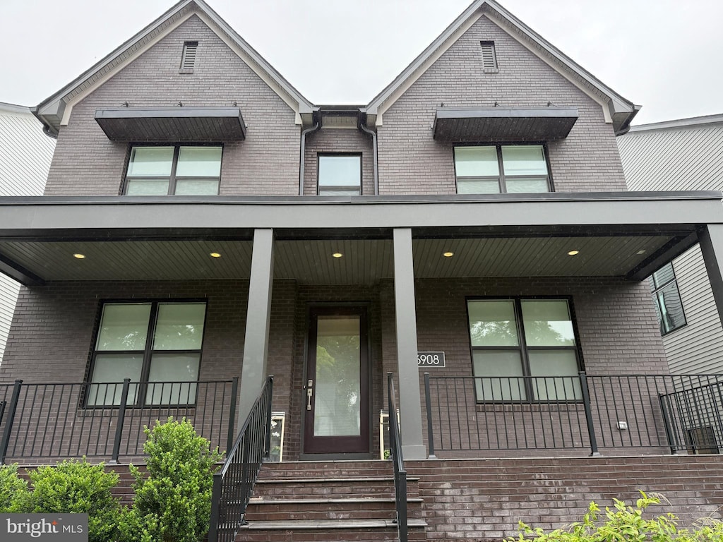 6908 Greyswood Rd, Bethesda, MD 20817 - view of front facade featuring brick siding and a porch