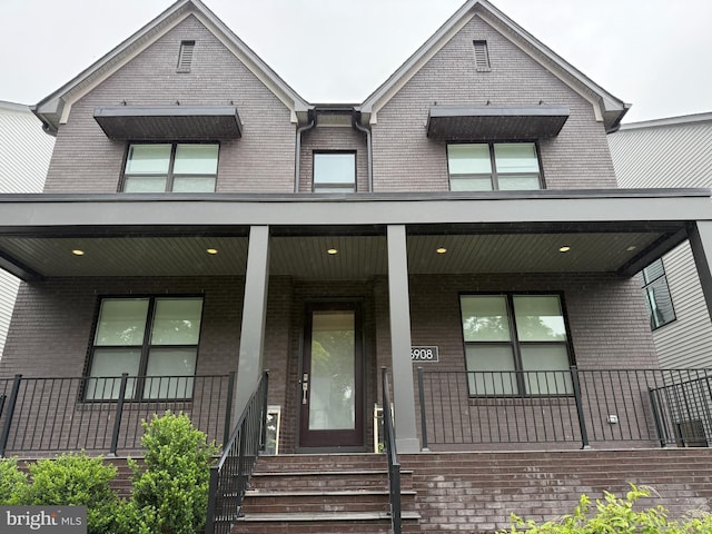 6908 Greyswood Rd, Bethesda, MD 20817 - view of front facade featuring brick siding and a porch
