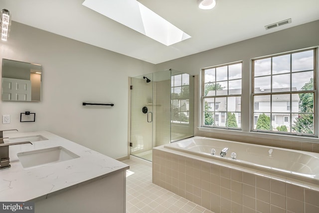 22 Billingsport Dr, Sicklerville, NJ 08081 - bathroom featuring a skylight, a bath, double vanity, a stall shower, and tile patterned flooring