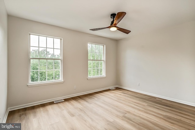 22 Billingsport Dr, Sicklerville, NJ 08081 - empty room with healthy amount of natural light, light wood finished floors, and a ceiling fan