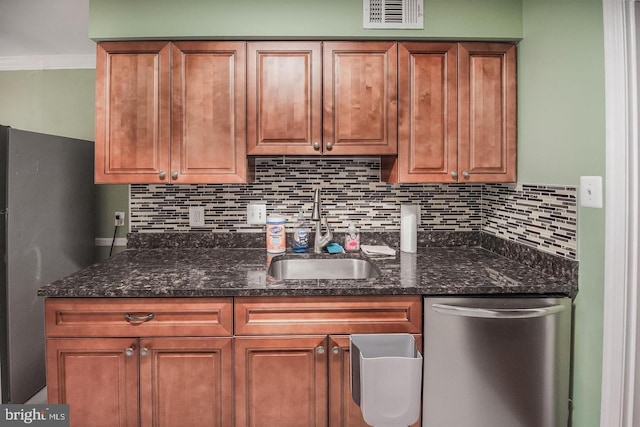 6611 Rosecroft Pl, Falls Church, VA 22043 - kitchen featuring appliances with stainless steel finishes, tasteful backsplash, brown cabinets, dark stone countertops, and ornamental molding