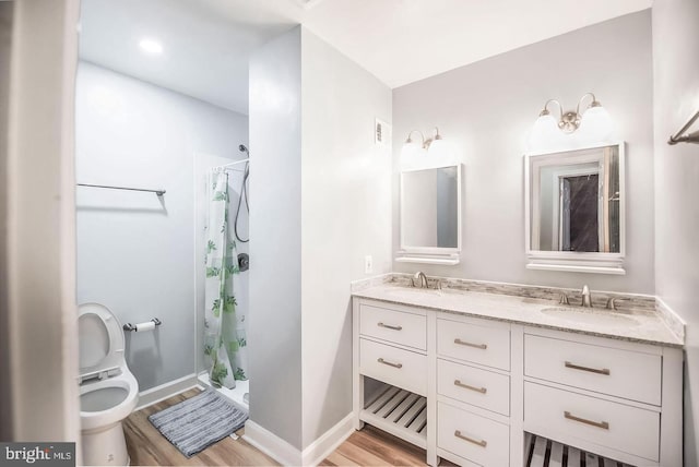 6611 Rosecroft Pl, Falls Church, VA 22043 - bathroom featuring wood finished floors, double vanity, and a shower with shower curtain