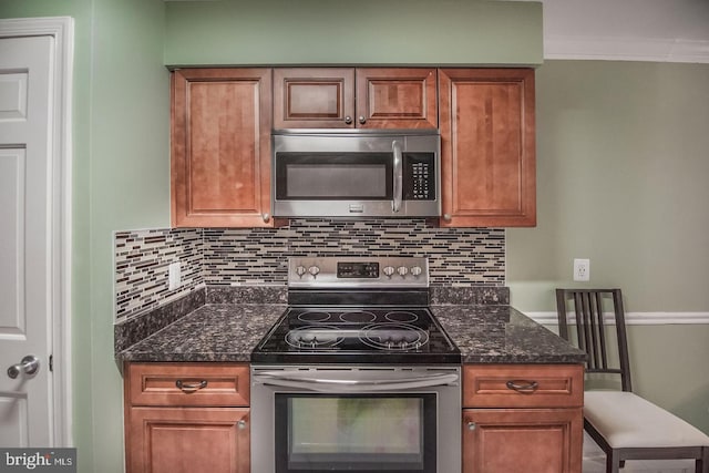 6611 Rosecroft Pl, Falls Church, VA 22043 - kitchen with appliances with stainless steel finishes, decorative backsplash, brown cabinets, crown molding, and dark stone countertops