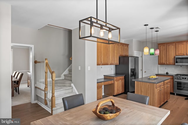 62 Brooks Rd, Moorestown, NJ 08057 - kitchen featuring appliances with stainless steel finishes, wood finished floors, dark countertops, and decorative backsplash