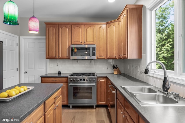 62 Brooks Rd, Moorestown, NJ 08057 - kitchen with appliances with stainless steel finishes, dark countertops, tasteful backsplash, and hanging light fixtures