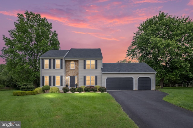 107 Heathfield Ct, Middletown, DE 19709 - colonial home with an attached garage, asphalt driveway, and a front yard