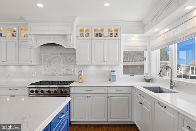 10 11th St, Beach Haven, NJ 08008 - kitchen with white cabinets, recessed lighting, backsplash, blue cabinetry, and glass insert cabinets