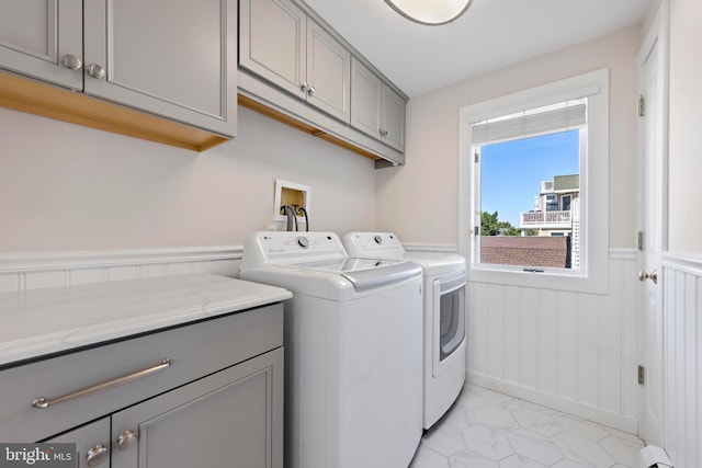 10 11th St, Beach Haven, NJ 08008 - washroom featuring washing machine and dryer, cabinet space, a wainscoted wall, and light marble finish floors