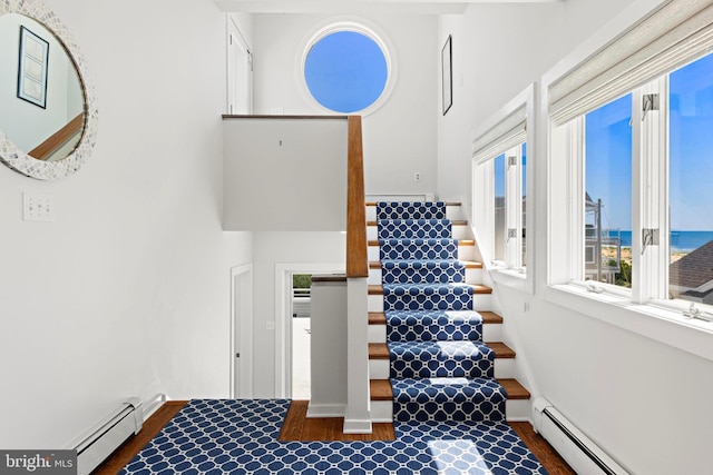 10 11th St, Beach Haven, NJ 08008 - stairs with a baseboard heating unit, healthy amount of natural light, wood finished floors, and a high ceiling