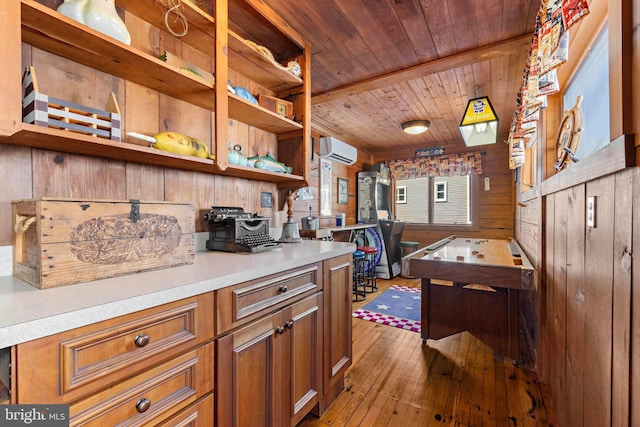 10 11th St, Beach Haven, NJ 08008 - kitchen with open shelves, wood walls, a wall mounted air conditioner, brown cabinetry, and light countertops