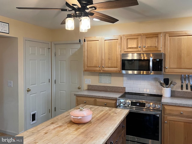 210 W Walnut St, Marietta, PA 17547 - kitchen with stainless steel appliances, ceiling fan, wooden counters, and decorative backsplash