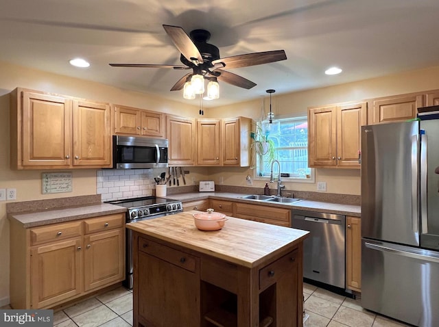 210 W Walnut St, Marietta, PA 17547 - kitchen featuring appliances with stainless steel finishes, wooden counters, light tile patterned floors, a ceiling fan, and a center island