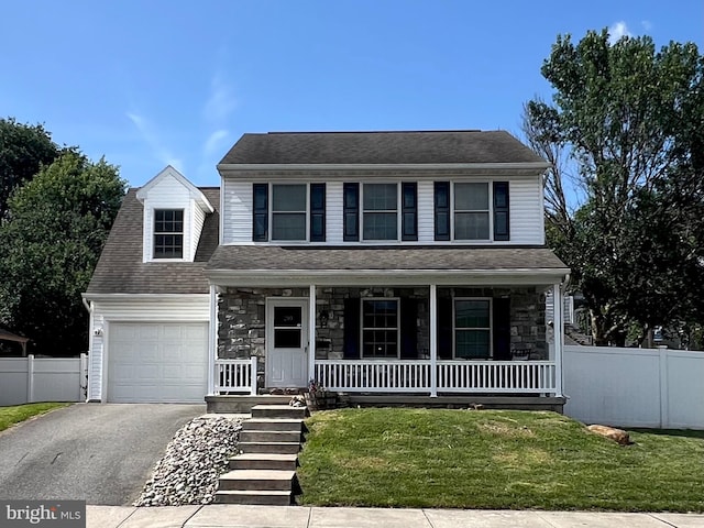 210 W Walnut St, Marietta, PA 17547 - view of front facade featuring covered porch, asphalt driveway, a garage, and stone siding