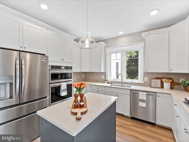 11433 Popes Head Rd, Fairfax, VA 22030 - kitchen featuring appliances with stainless steel finishes, white cabinetry, decorative backsplash, a center island, and recessed lighting