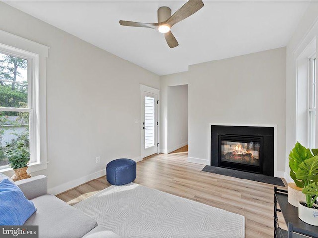 11433 Popes Head Rd, Fairfax, VA 22030 - living area with a ceiling fan, light wood-type flooring, and a fireplace with flush hearth