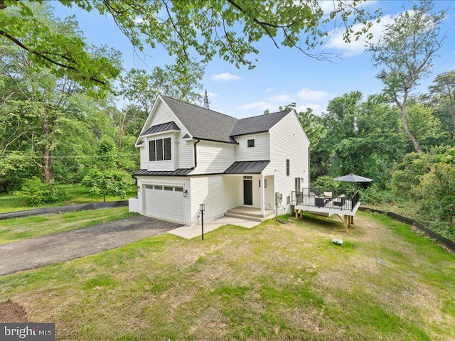 11433 Popes Head Rd, Fairfax, VA 22030 - view of front of home featuring a standing seam roof, an attached garage, driveway, a metal roof, and a front lawn