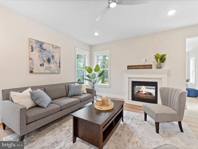 11433 Popes Head Rd, Fairfax, VA 22030 - living room with light wood-style flooring, a multi sided fireplace, a ceiling fan, and recessed lighting