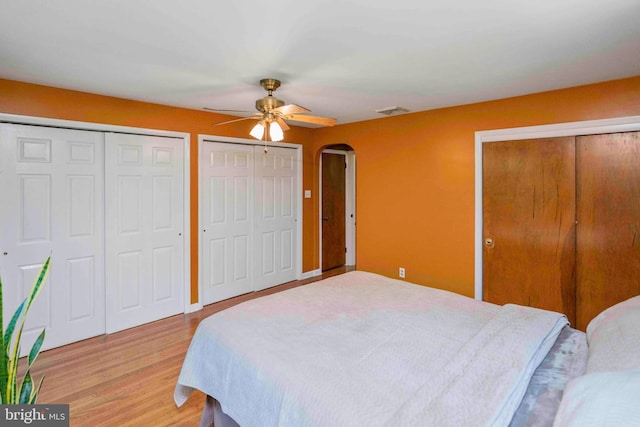 803 Libby Ln, Langhorne, PA 19053 - bedroom with two closets, light wood finished floors, arched walkways, and ceiling fan