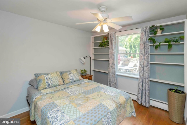 803 Libby Ln, Langhorne, PA 19053 - bedroom featuring baseboard heating, wood finished floors, and a ceiling fan
