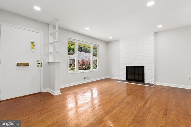 10409 Royalton Ter, Silver Spring, MD 20901 - unfurnished living room featuring a fireplace, wood finished floors, and recessed lighting