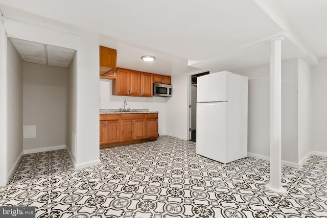 10409 Royalton Ter, Silver Spring, MD 20901 - kitchen with freestanding refrigerator, stainless steel microwave, and brown cabinets